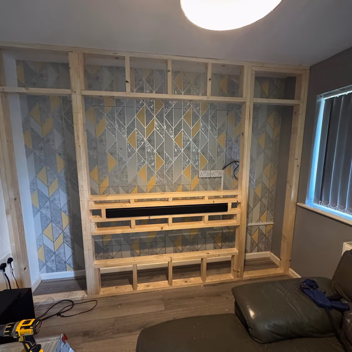 Media wall, white, being installed