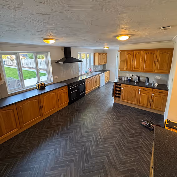 Before shot of a kitchen with older wooden units