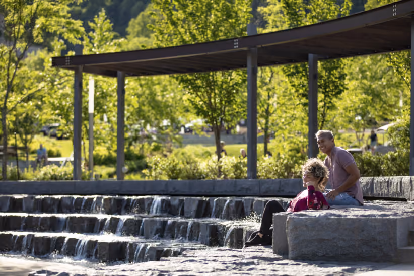 A couple relaxing at the waterfall at South Grove