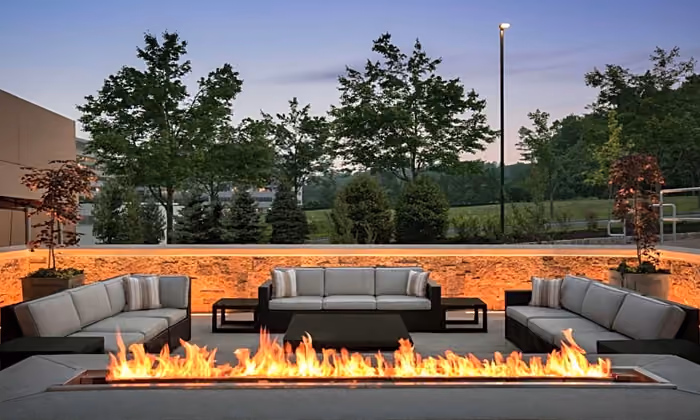 Lounge seating and fireplace lit on the Glass House Terrace