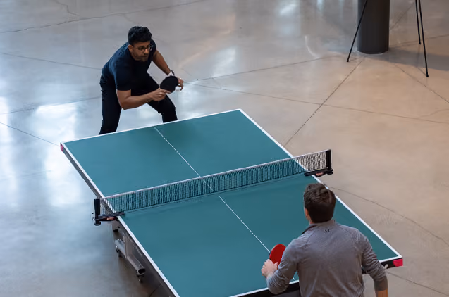 Two people playing each other in ping pong