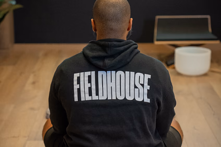 A Fieldhouse staff member meditating on the floor