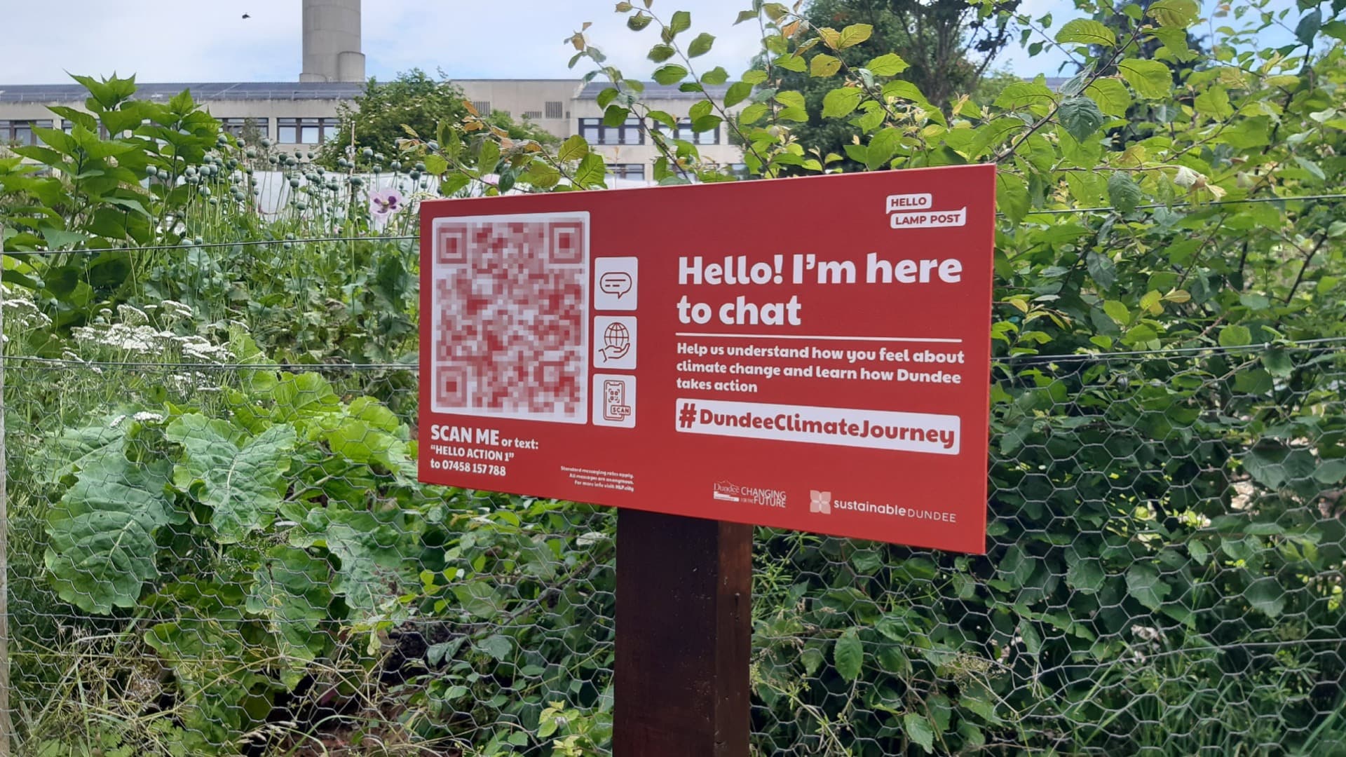 Close up of sign in a park in Dundee asking residents to scan the QR code to chat about climate change