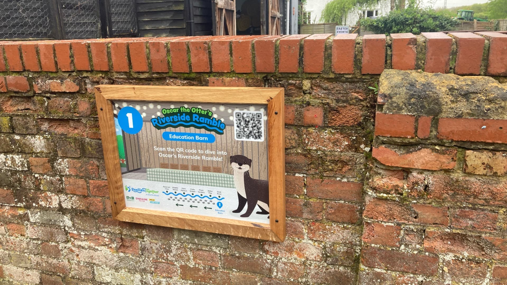 Close up of Riverside Ramble interactive trail signage at Standalone farm on a brick wall, in partnership with Central Bedfordshire Council