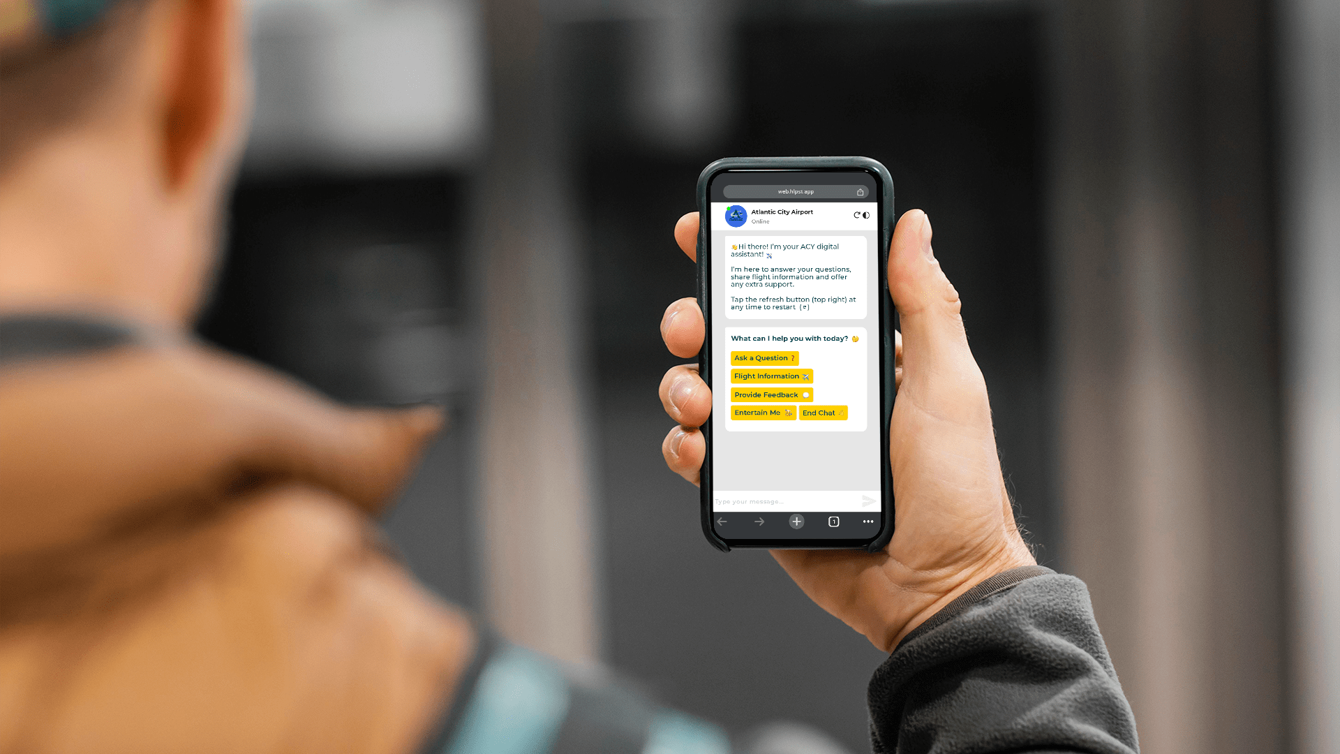 A person holds a smartphone displaying a conversation. with a HLP digital assistant.. The screen shows text options highlighted in yellow.
