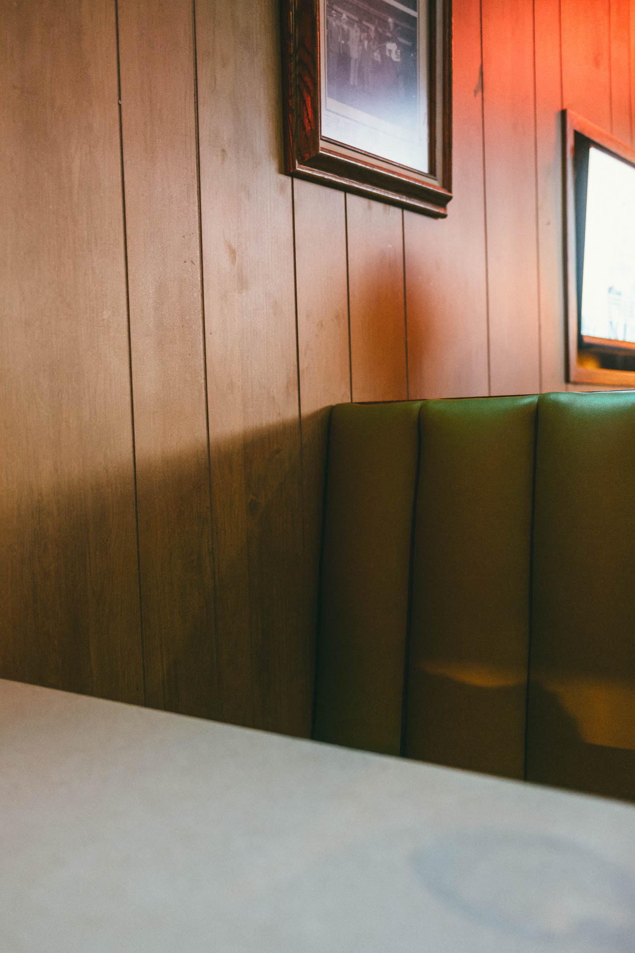 Empty green booth with a shadow of a person