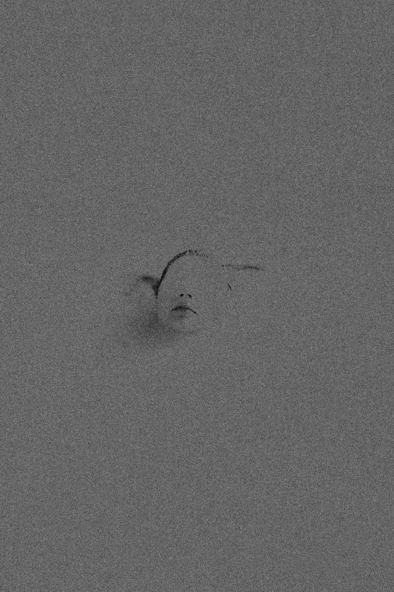 faceless woman coming out of grainy water