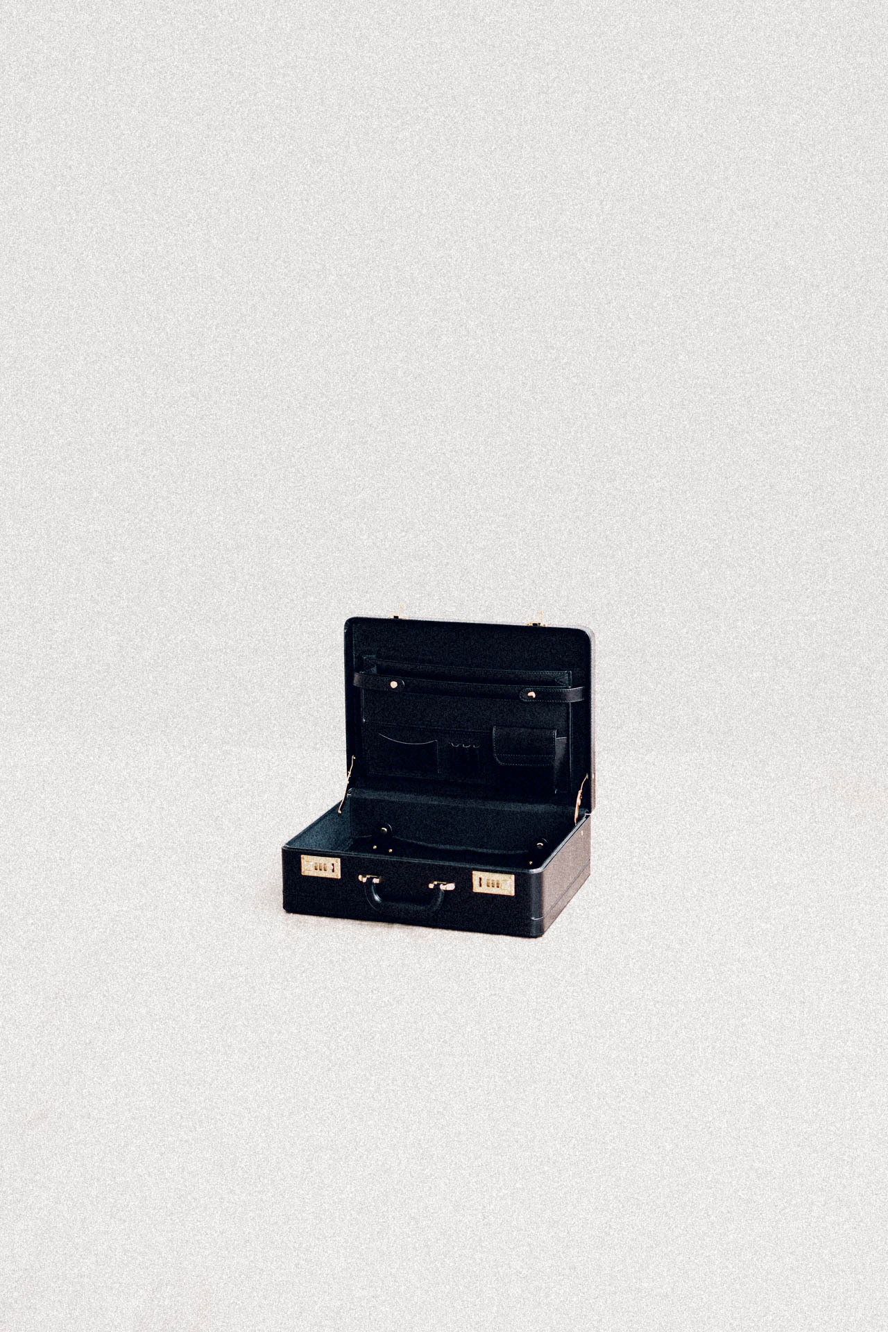 an empty briefcase from Saint Citrus in a white void room