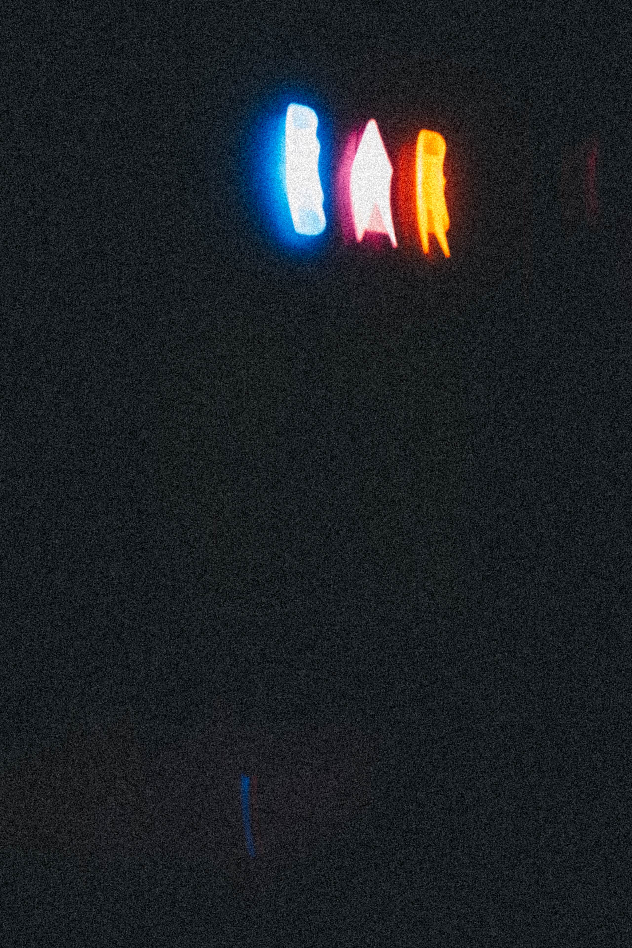 a blue, orange, and red neon bar sign with motion