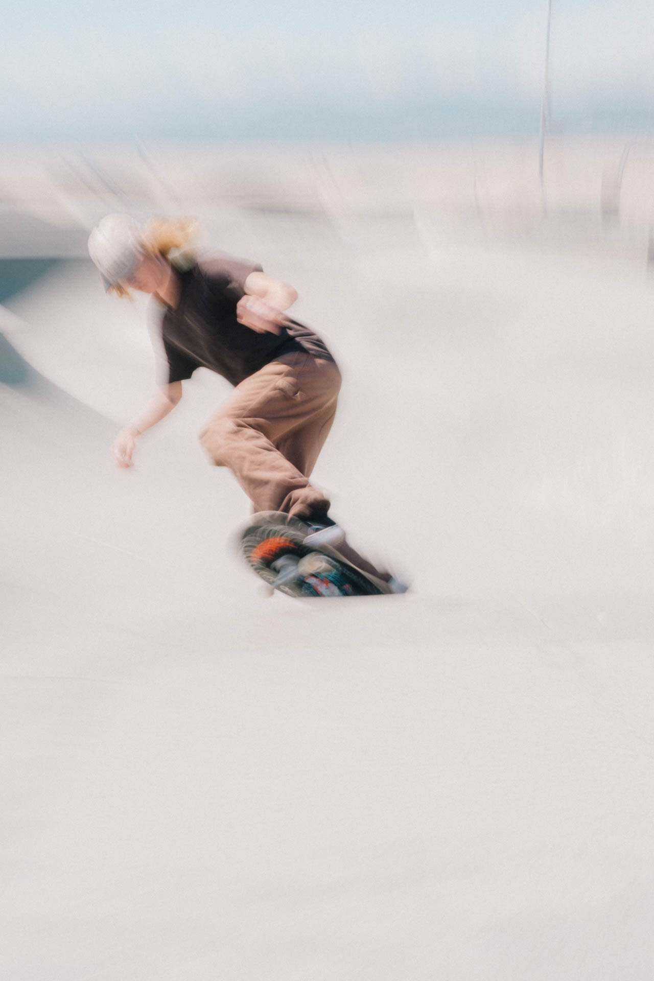 Venice Beach skateboarder in motion on a sunny day by the beach