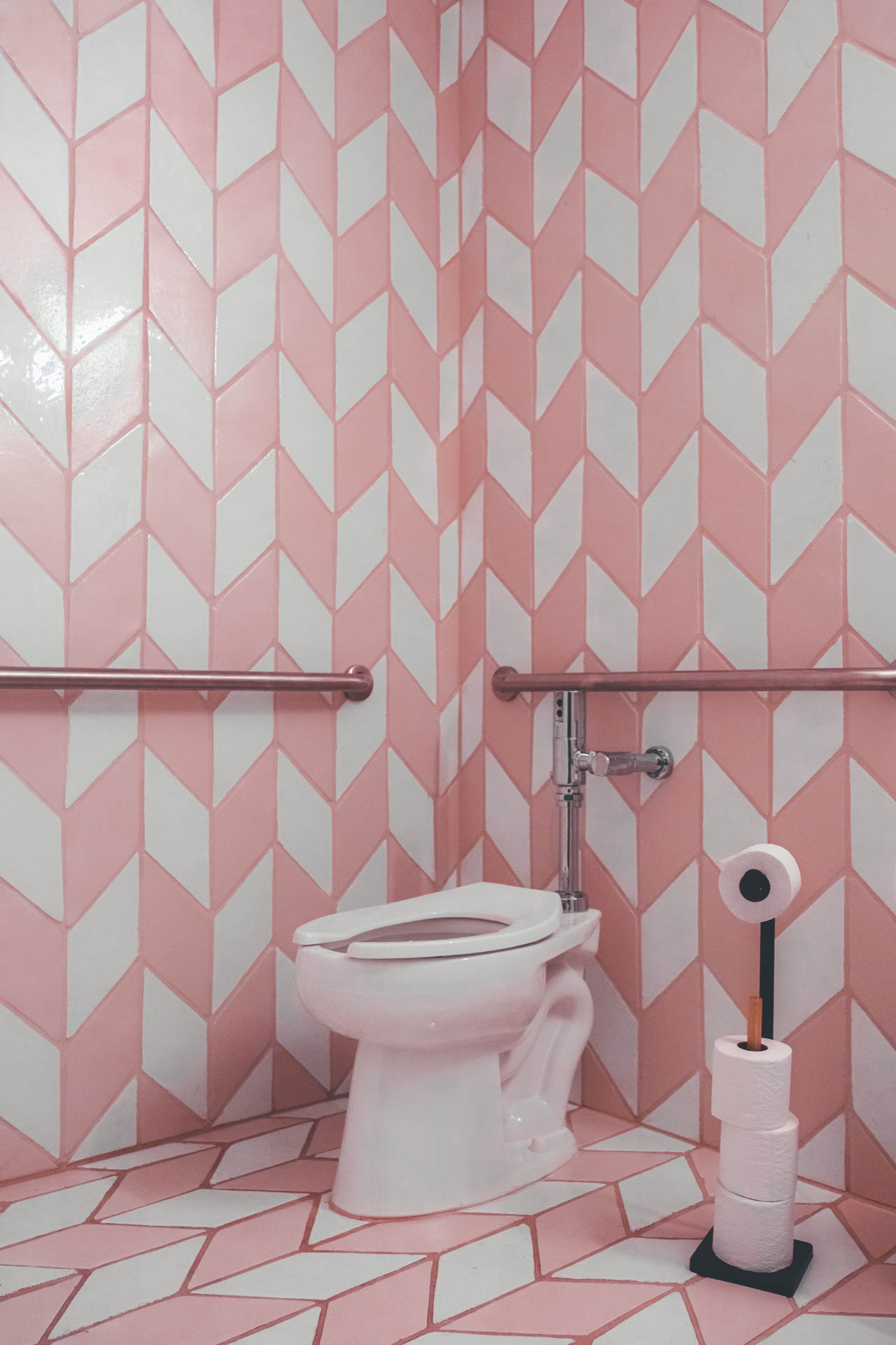 cotton candy bathroom with pink and white tile lining the walls