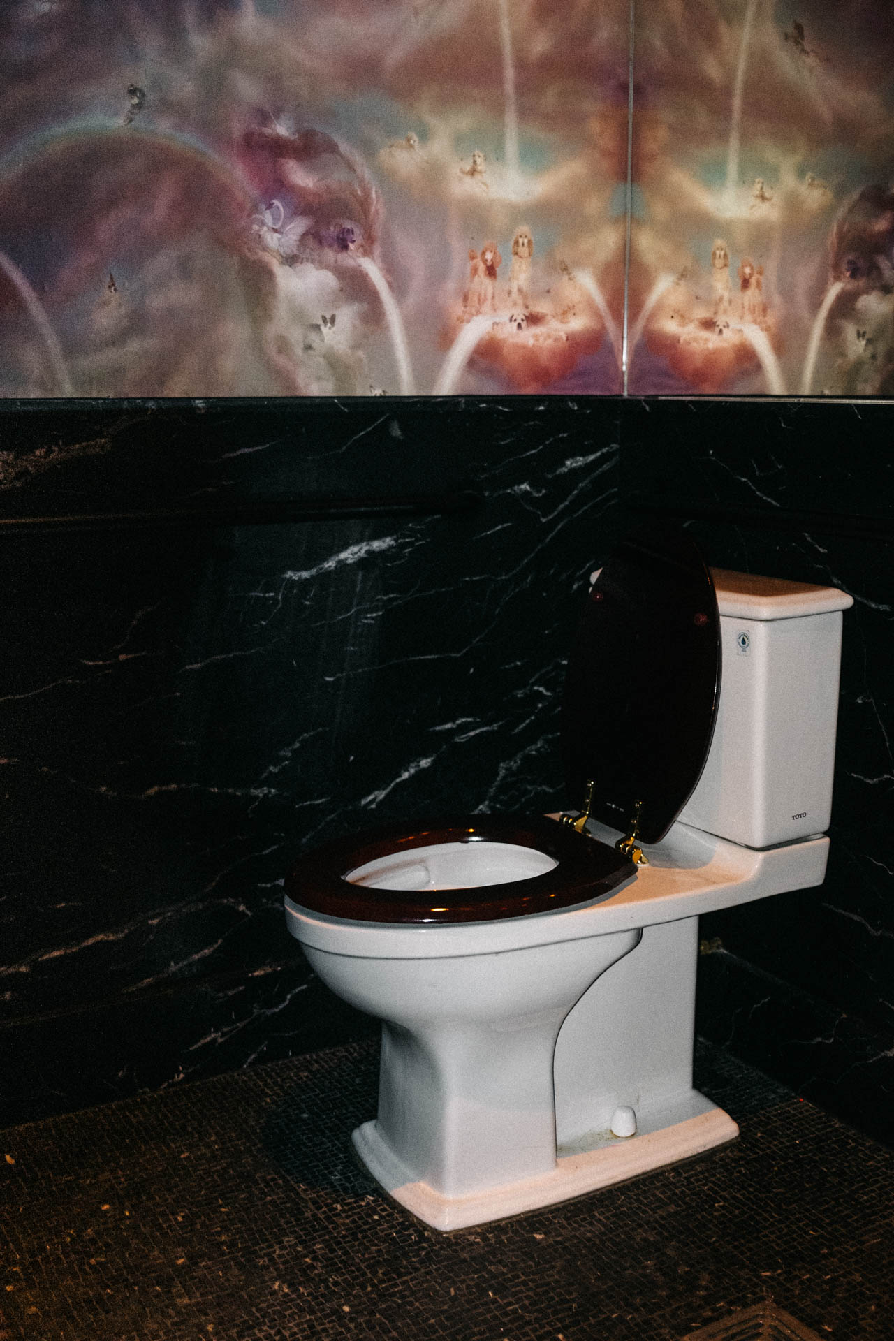 toilet in a reflective wallpaper bathroom
