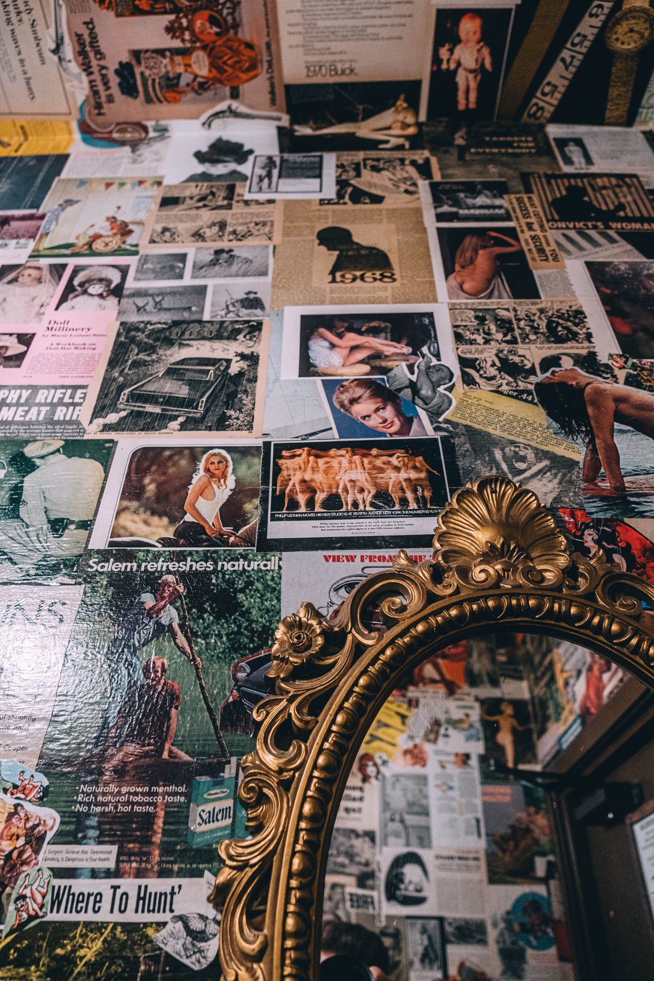 stickers and posters lining the walls of a bathroom