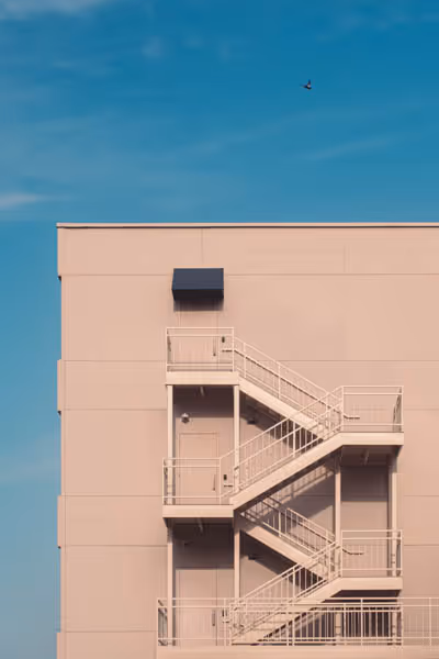 pink building near sunset with stairs thumbnail