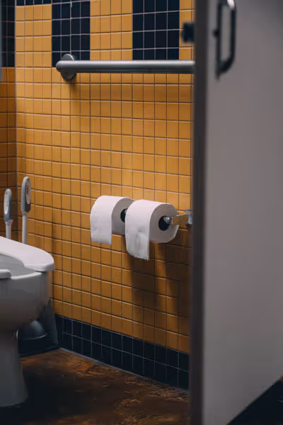 two rolls of toilet paper in a yellow bathroom