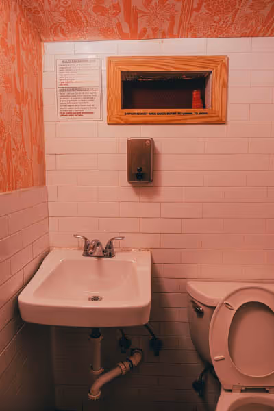 the sink in an orange bathroom