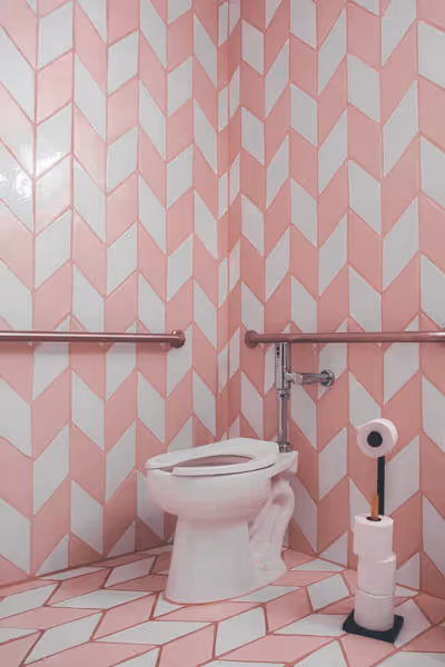 cotton candy bathroom with pink and white tile lining the walls
