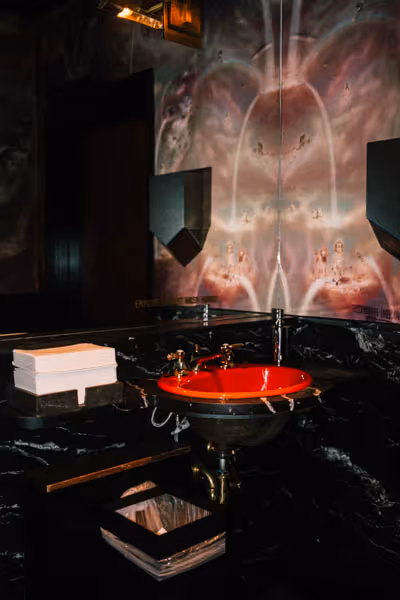 bright red sink and napkins in a holographic wallpaper bathroom