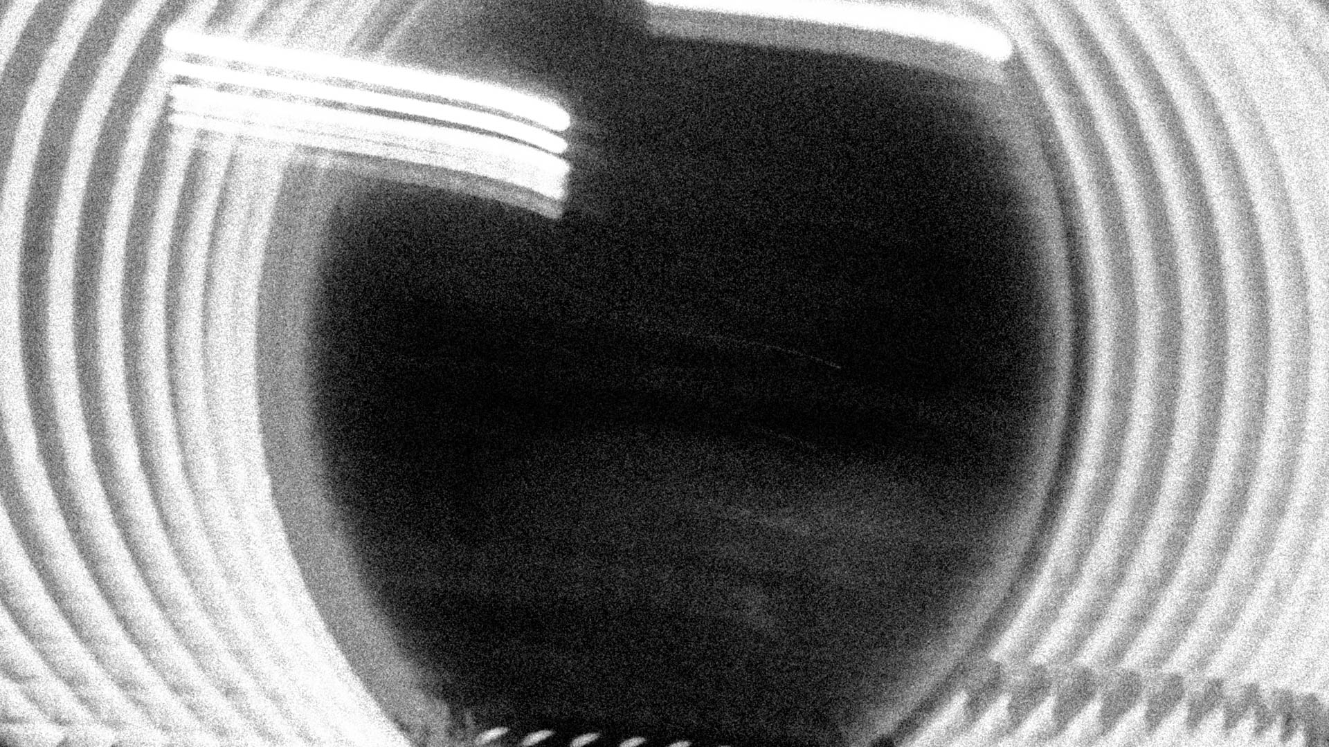 Long exposure light trails on the left and right of a mirror
