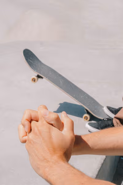 Holding hands with a skateboard at the beach in Venice