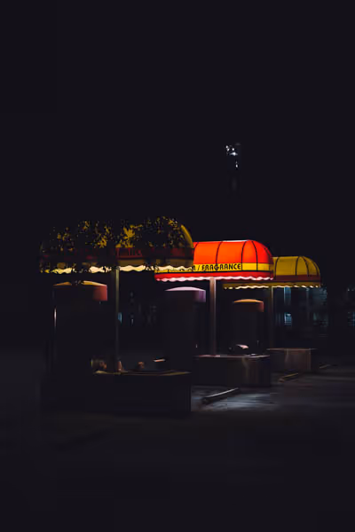vacuum and fragrance. the yellow and red awnings of a retro car wash at night