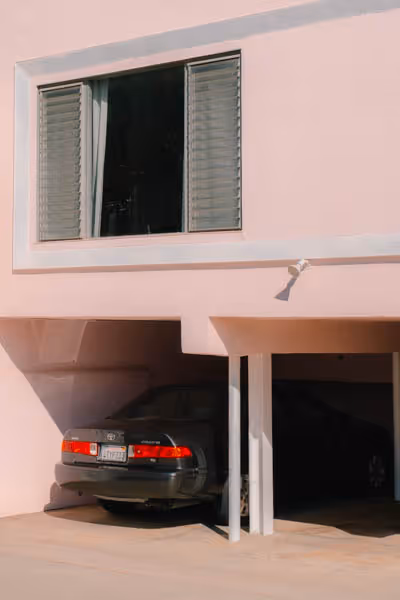 black car in a pink building garage in los angeles