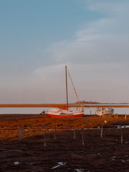 a red boat by the bay