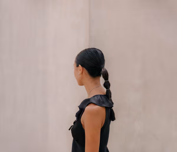 a woman looking to the left with a ponytail in Sicily