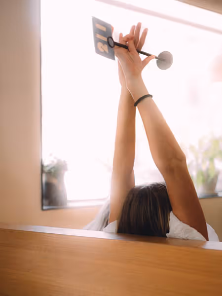 woman stretching her arms up at a restaurant