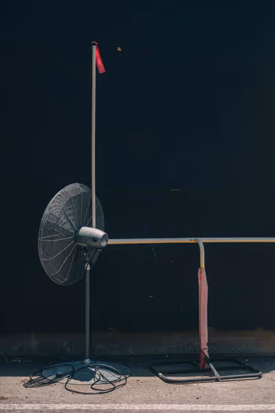 oscillating fan and small field goal post in an alleyway
