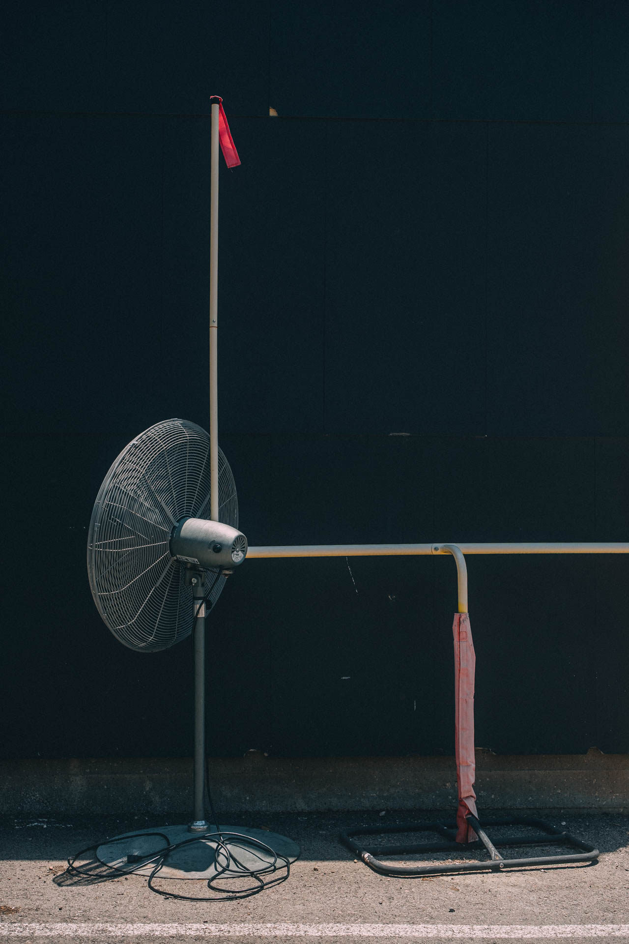 oscillating fan and small field goal post in an alleyway