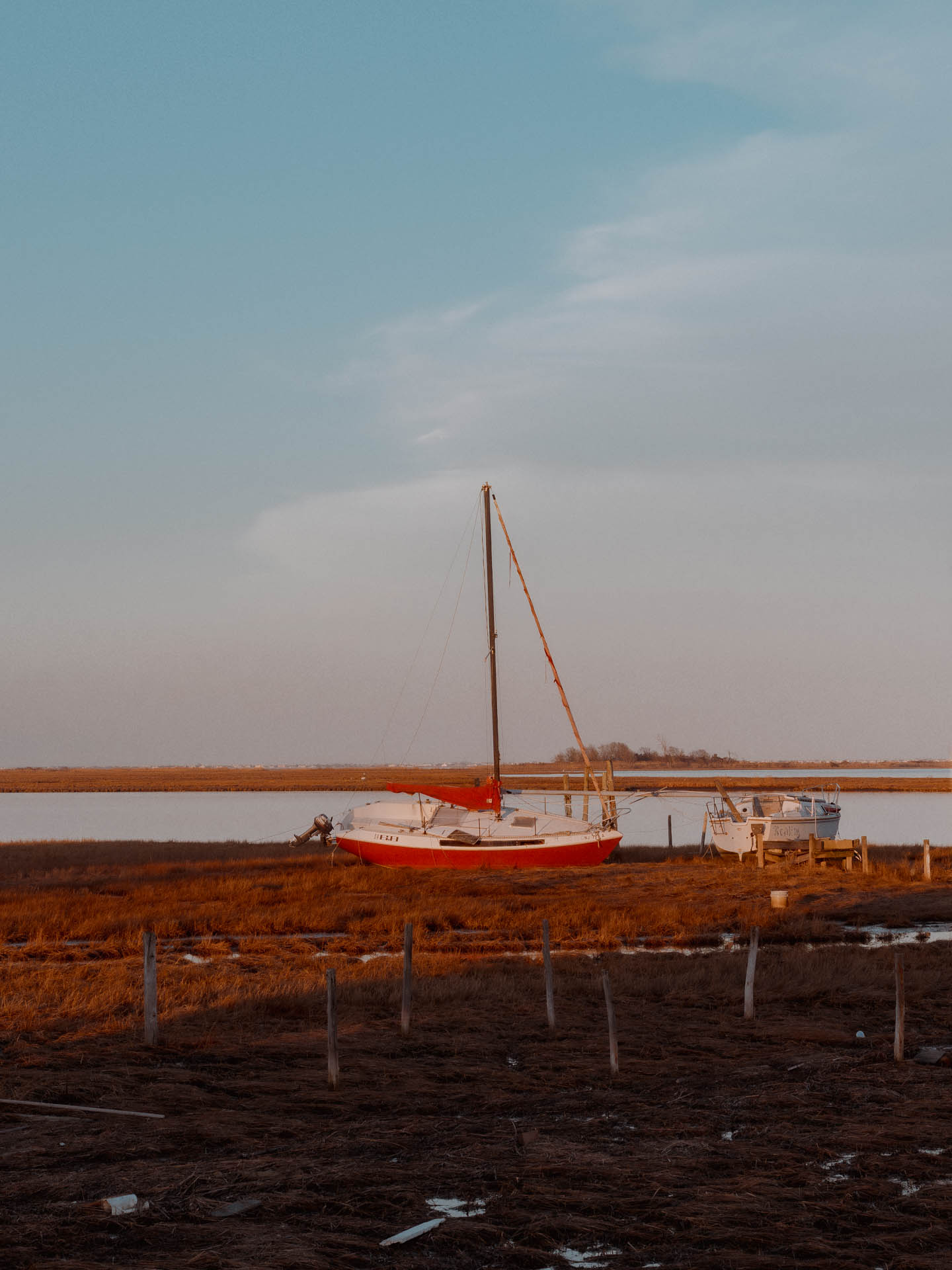 a red boat by the bay