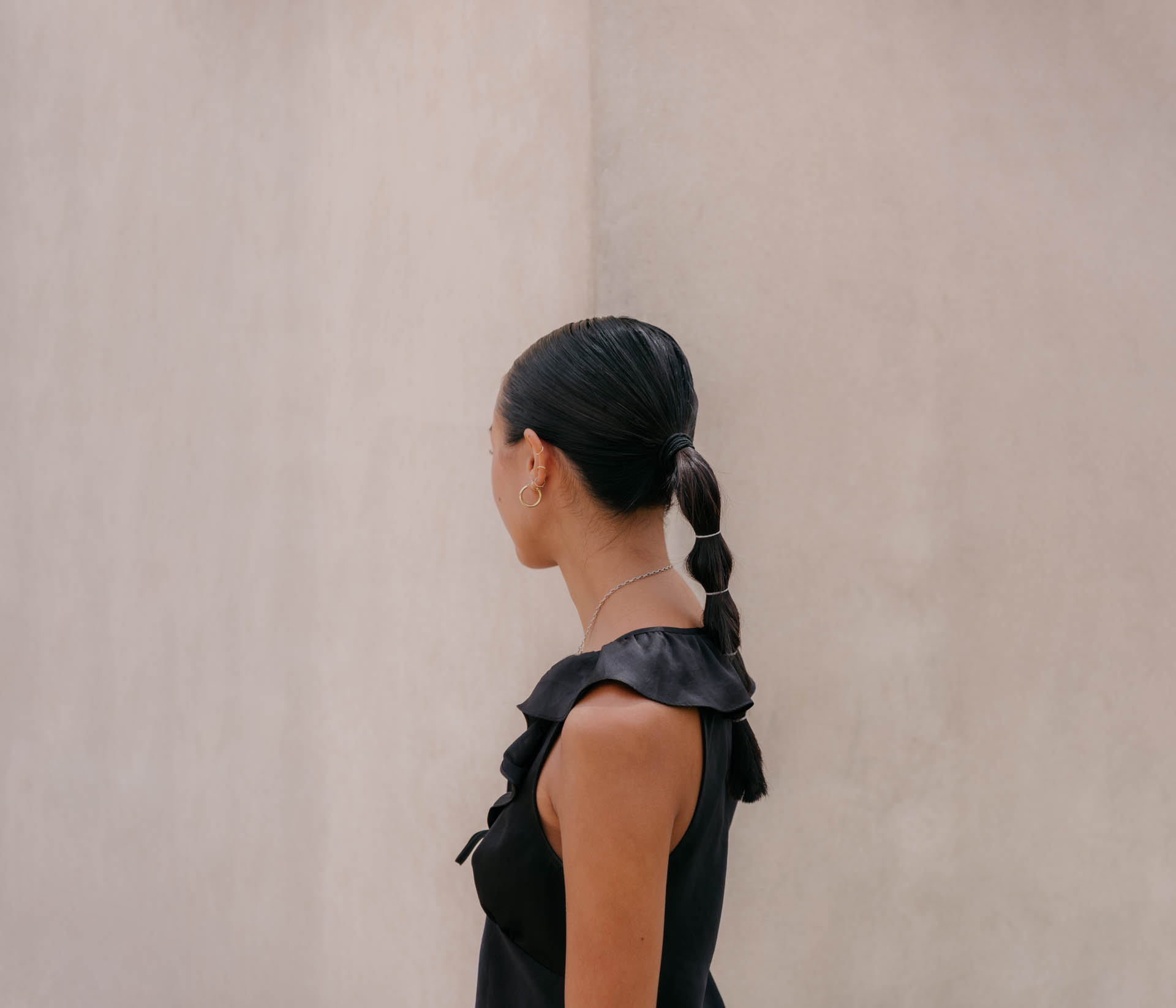 a woman looking to the left with a ponytail in Sicily