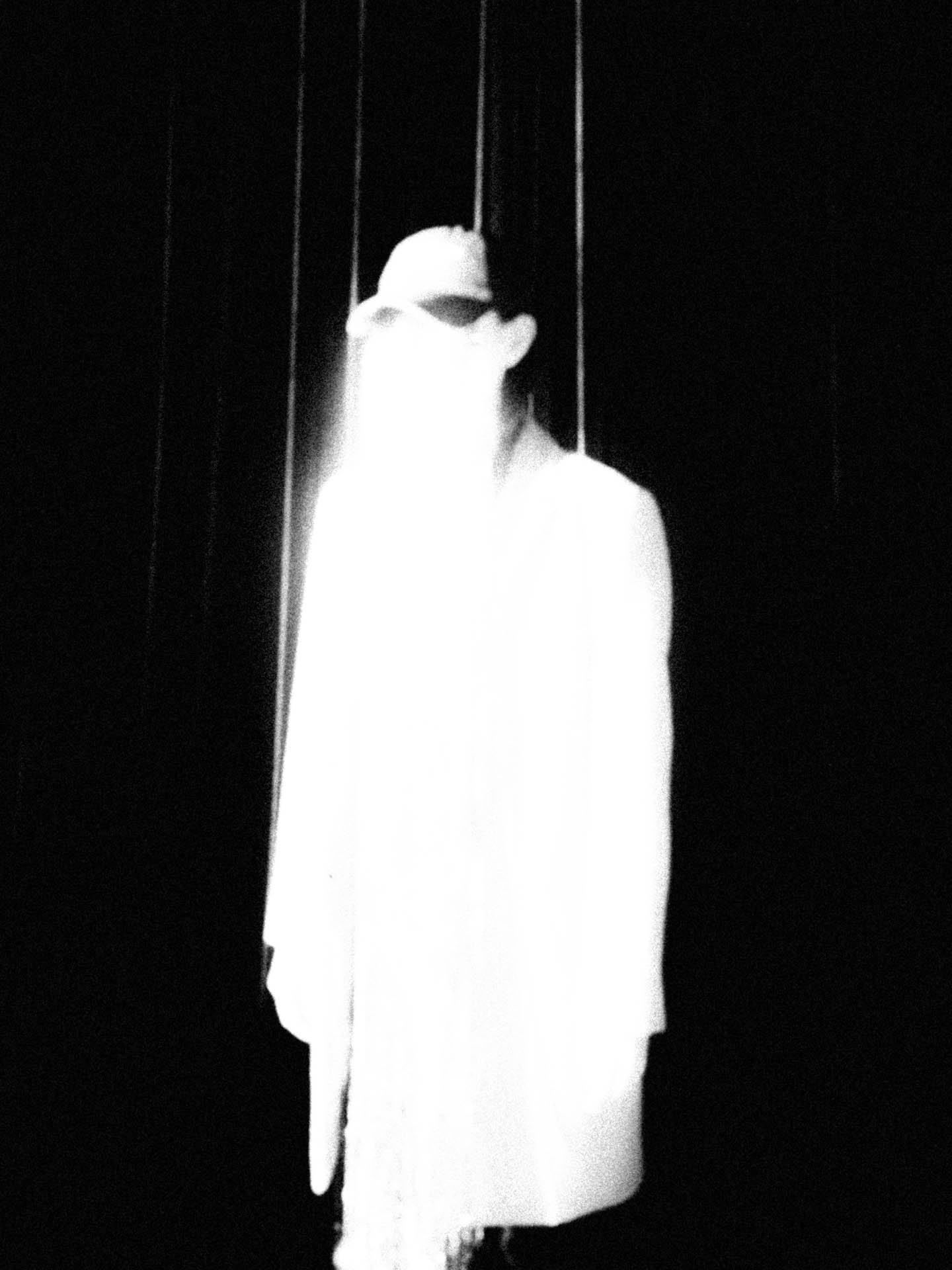 a ghostly black and white woman in a hat