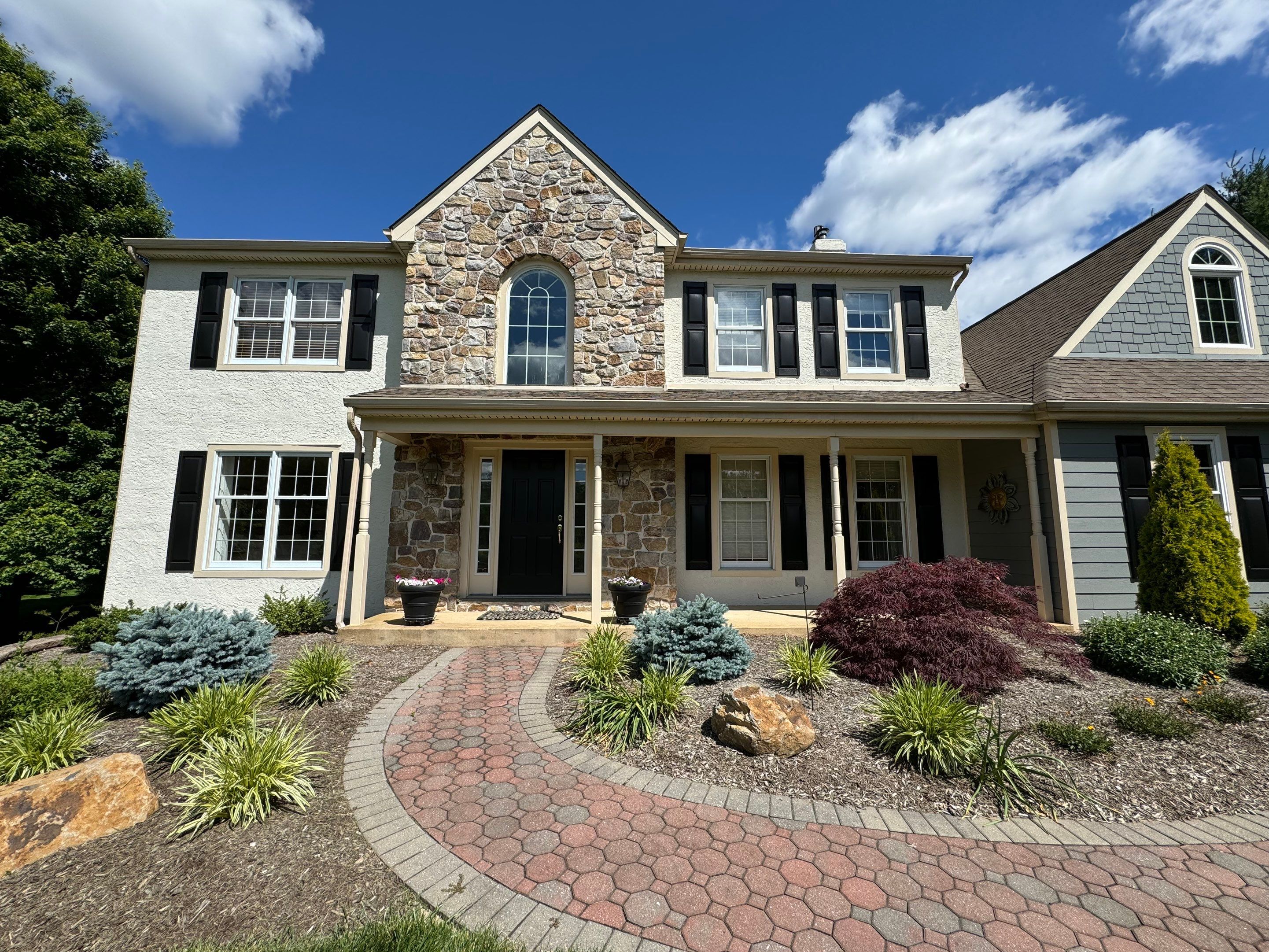 Newly renovated home with new siding and shingles from E&E General Contracting.