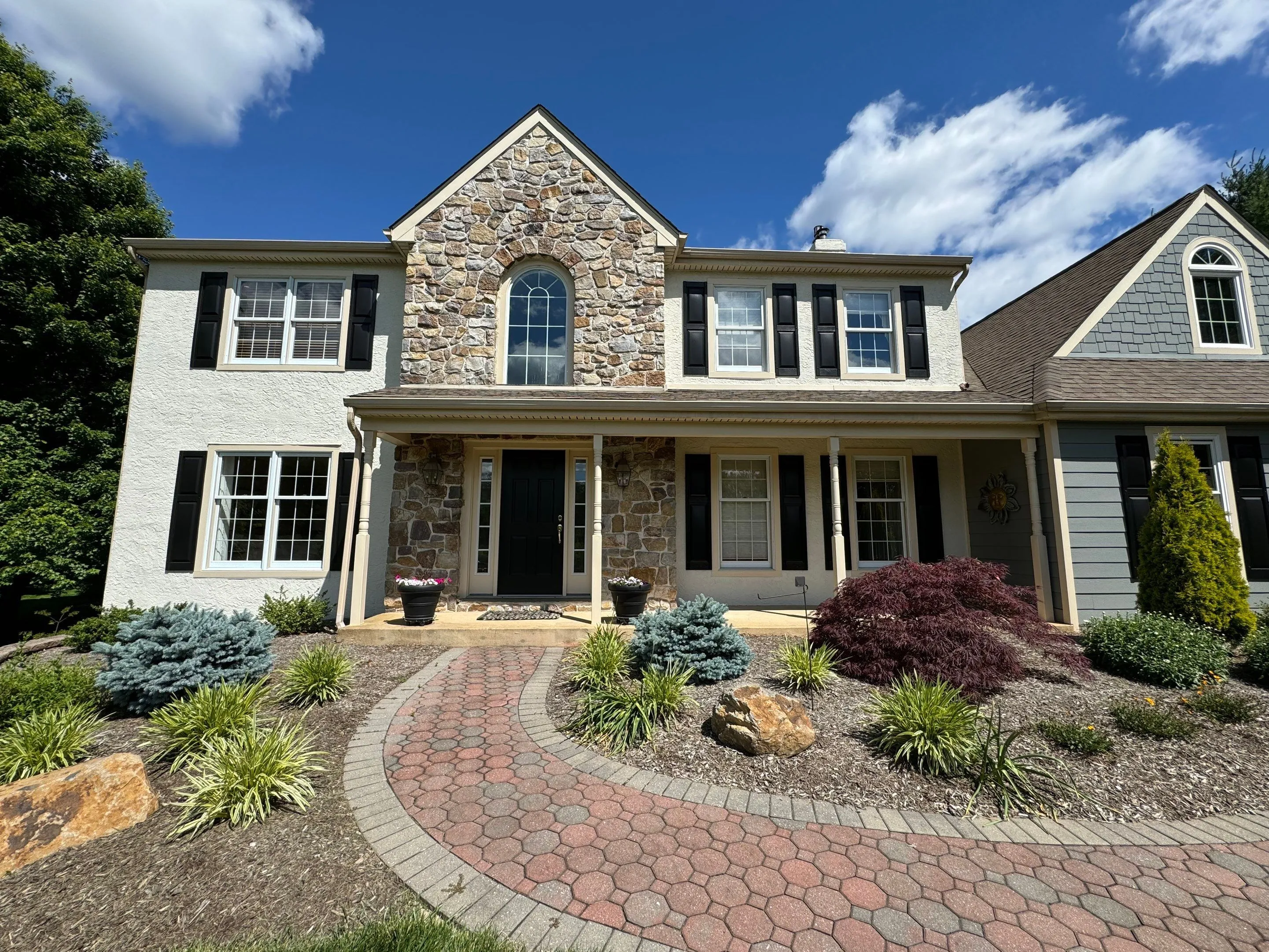 Newly renovated home with new siding and shingles from E&E General Contracting.
