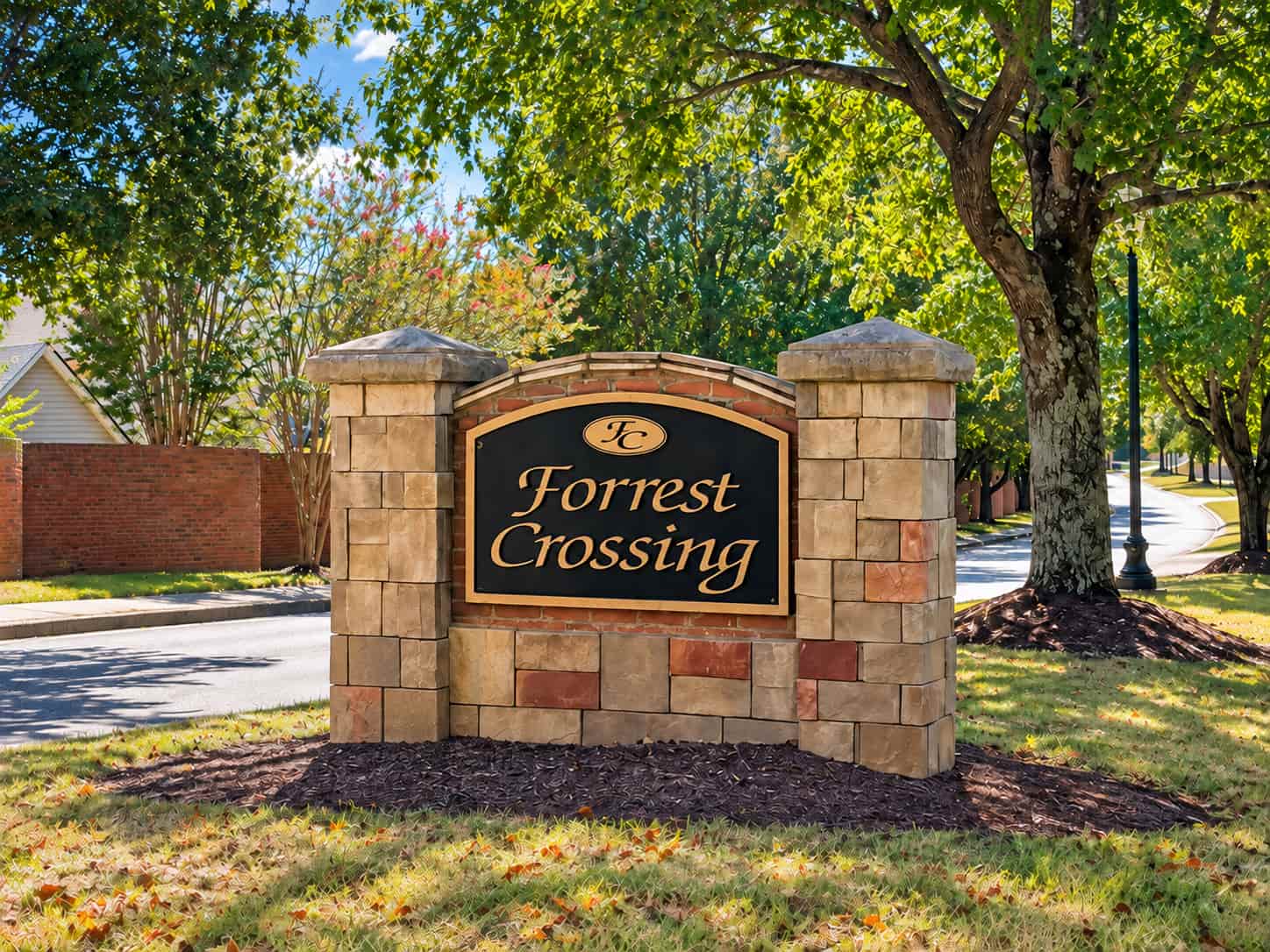 Forrest Crossing stone entrance sign under mature shade trees, Franklin, Tennessee