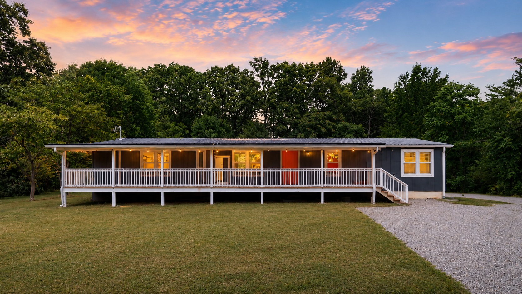 Front of 9464 Sugar Tree Rd at dusk with the covered deck lit up