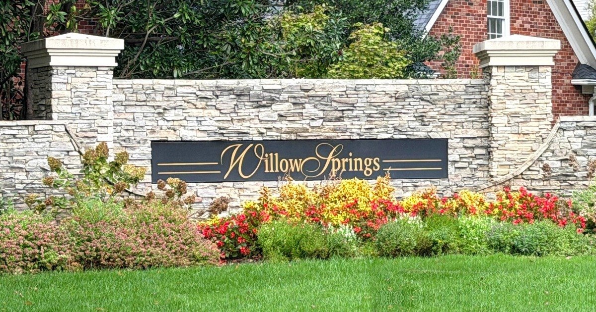 WillowSprings stacked stone entrance wall and sign with colorful flower beds, Franklin, Tennessee