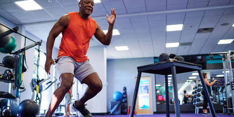 Man doing a box jump exercise at the gym.