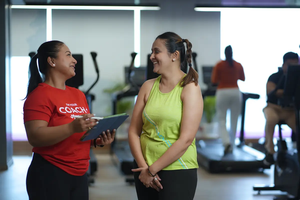 A stylized overlay of fitness app screens and messaging visuals represents Anytime Fitness’s personalized plans, tracking tools, and data-driven support tailored to individual goals.