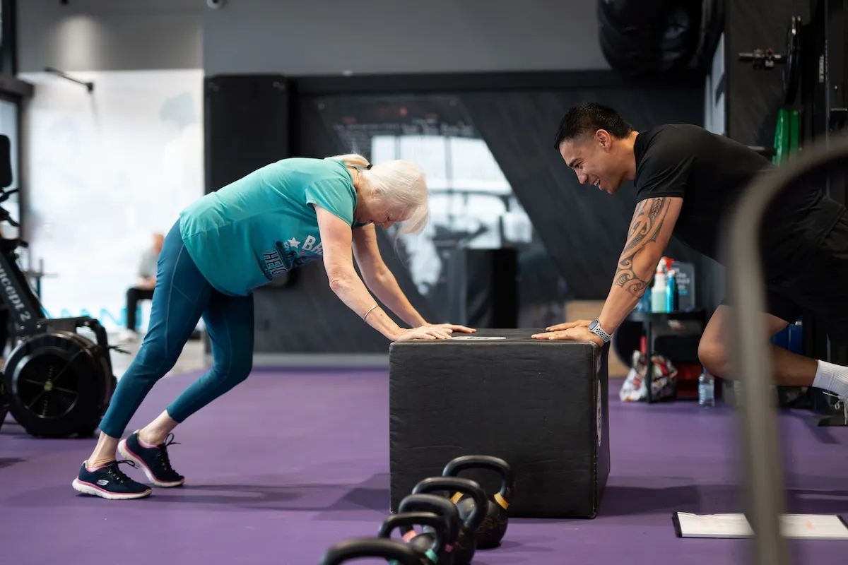 woman training with rope and personal trainer