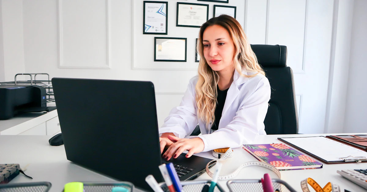 Female nurse practitioner listening during a consultation at her desk