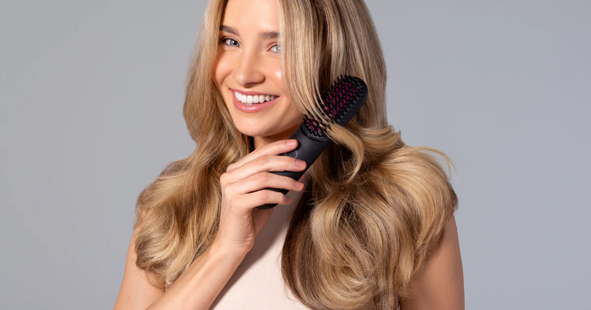 Woman running her fingers through her hair in soft light