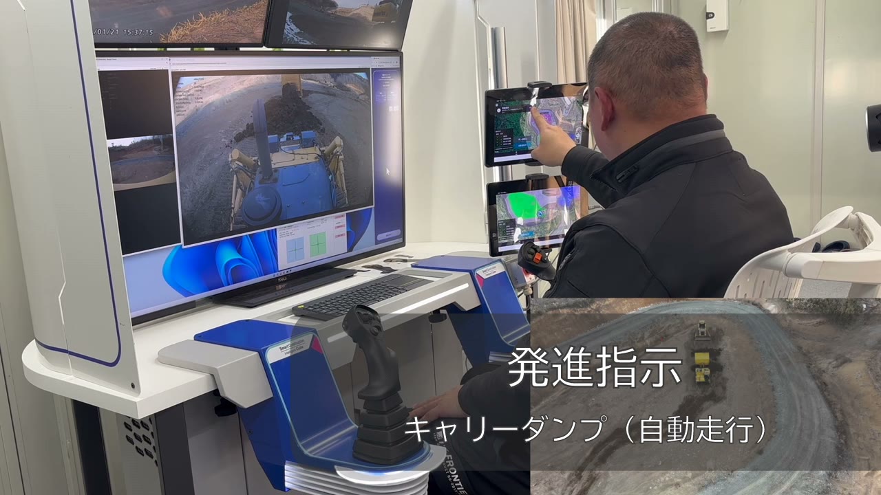 遠隔コックピットから自動運転車両とブルドーザーを操作・監視する様子