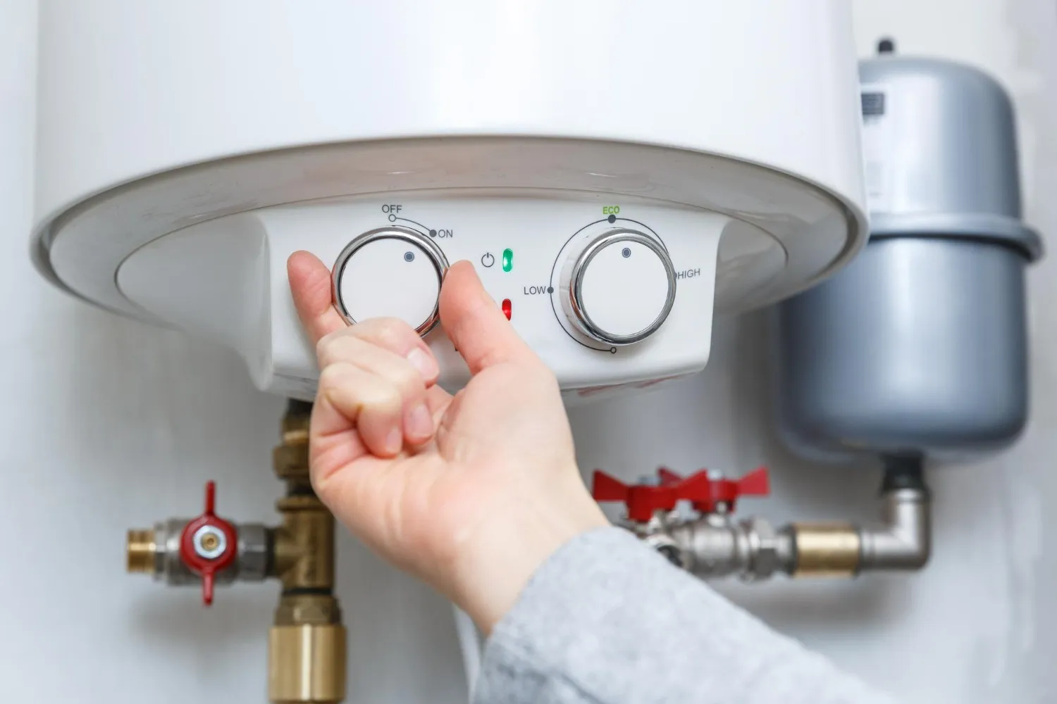 Image of a man working on kitchen plumbing