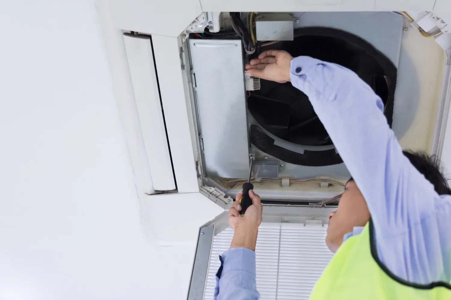 Image of a man working on kitchen plumbing
