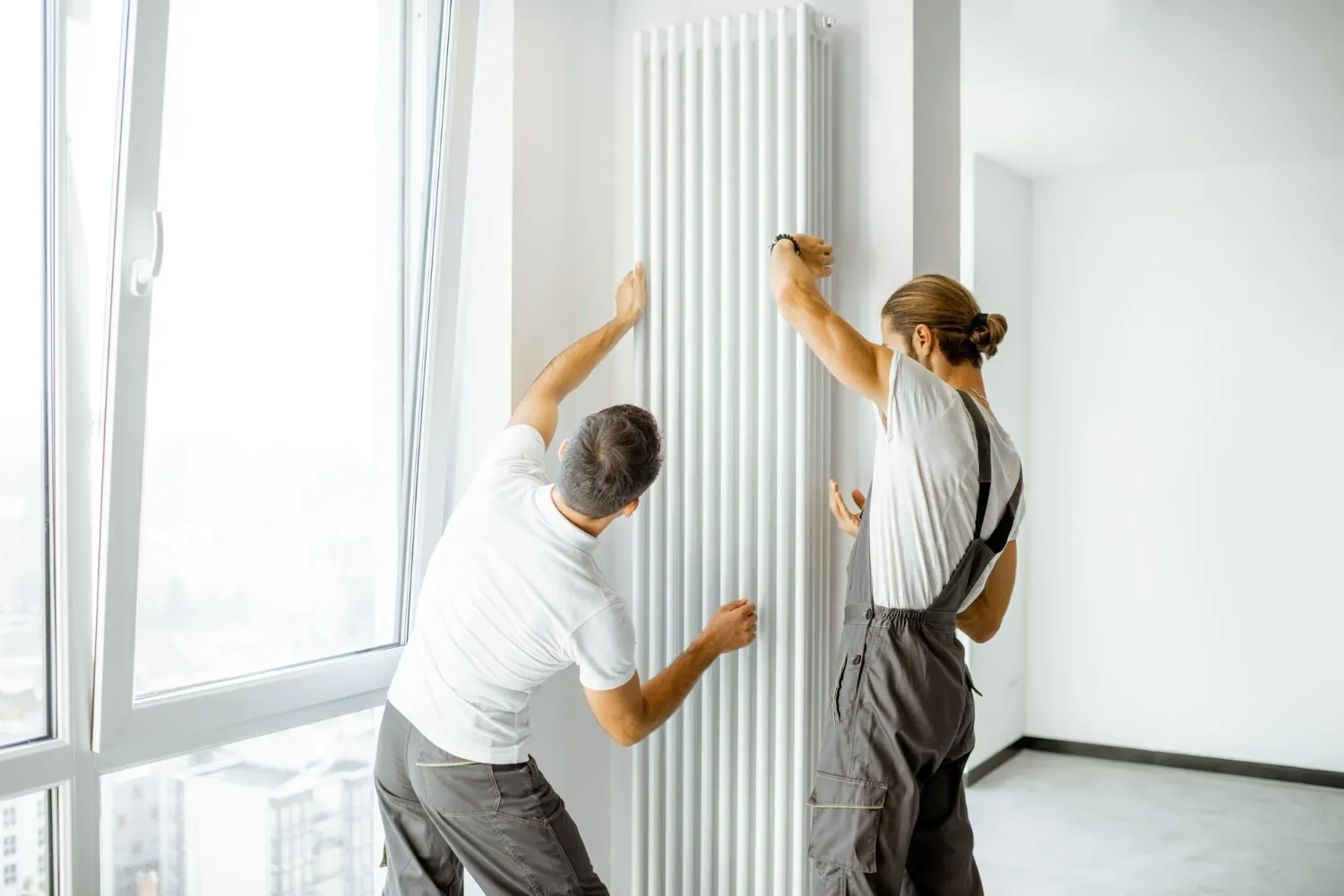 Image of a man working on kitchen plumbing