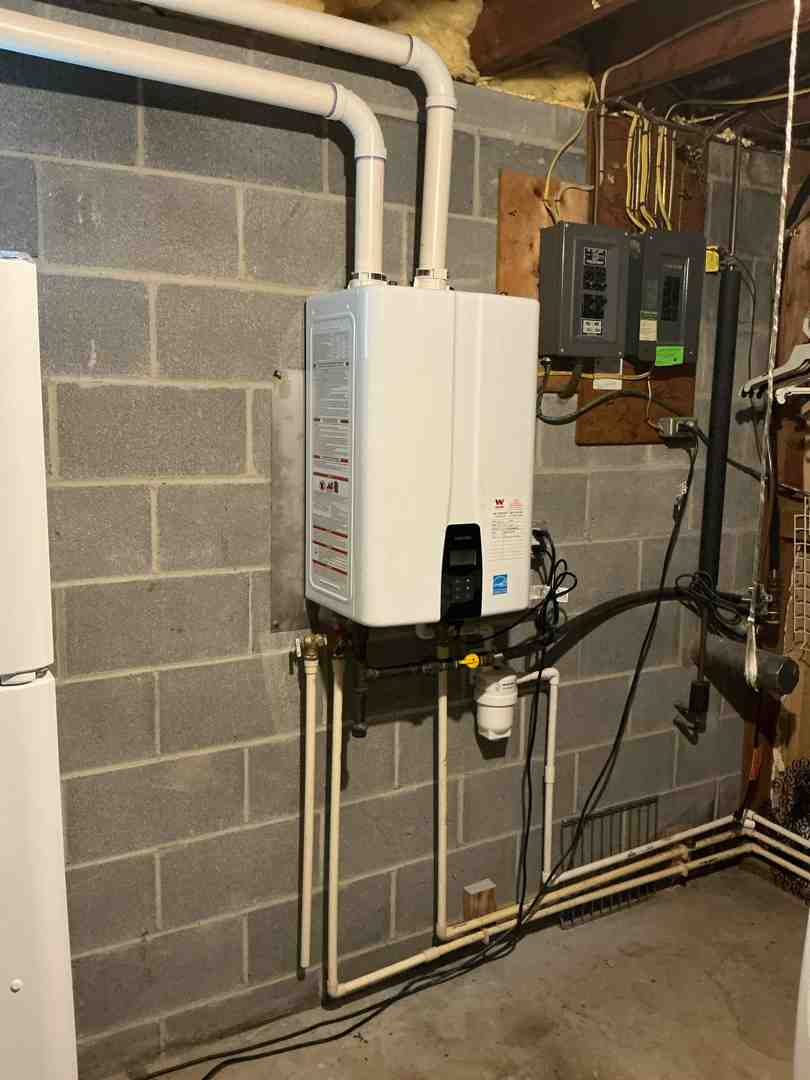 Technician installing a modern tankless water heater - certified plumbing technician in ijamsville md