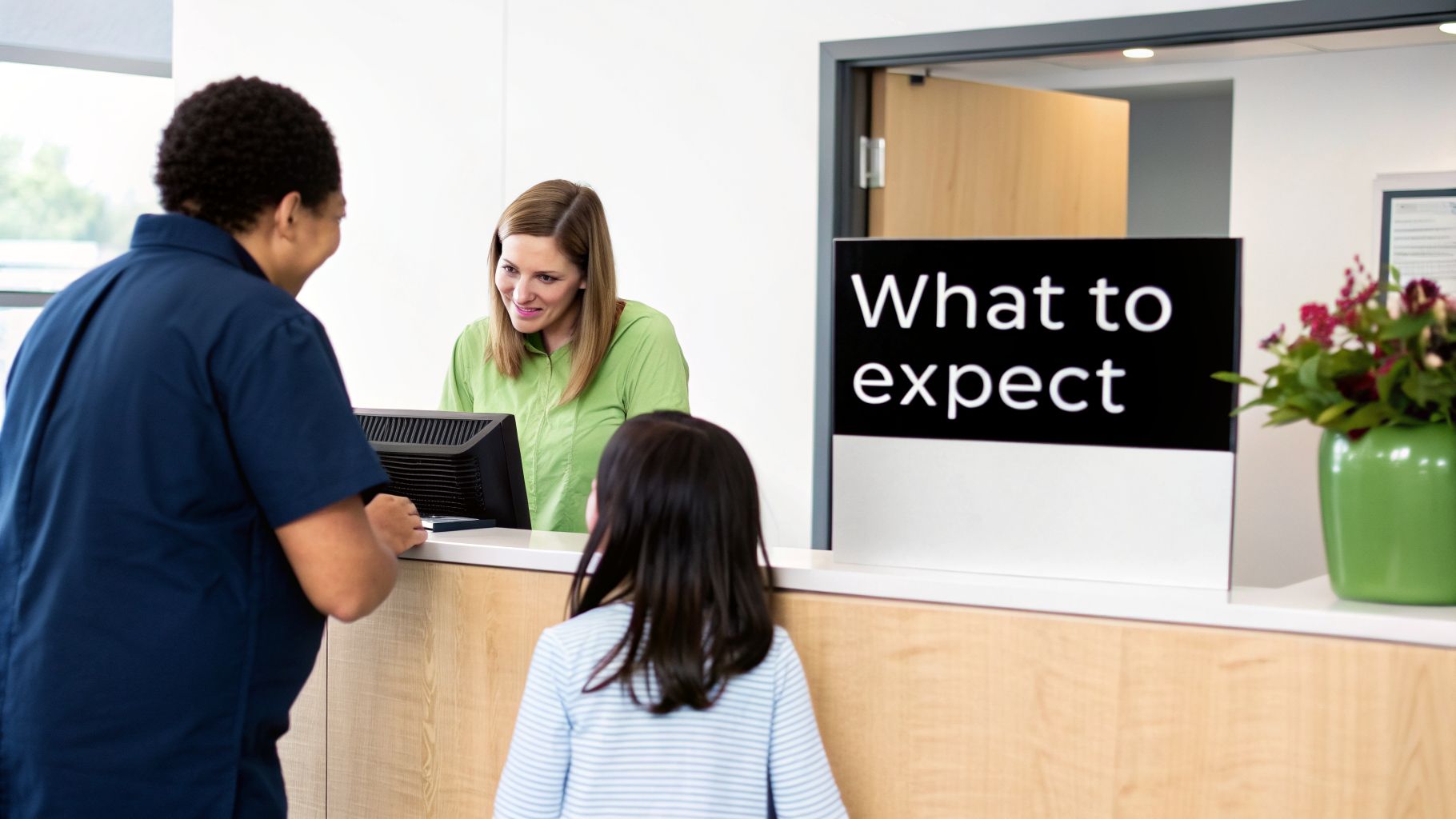 A friendly female receptionist assists a parent and child at a modern clinic's front desk.